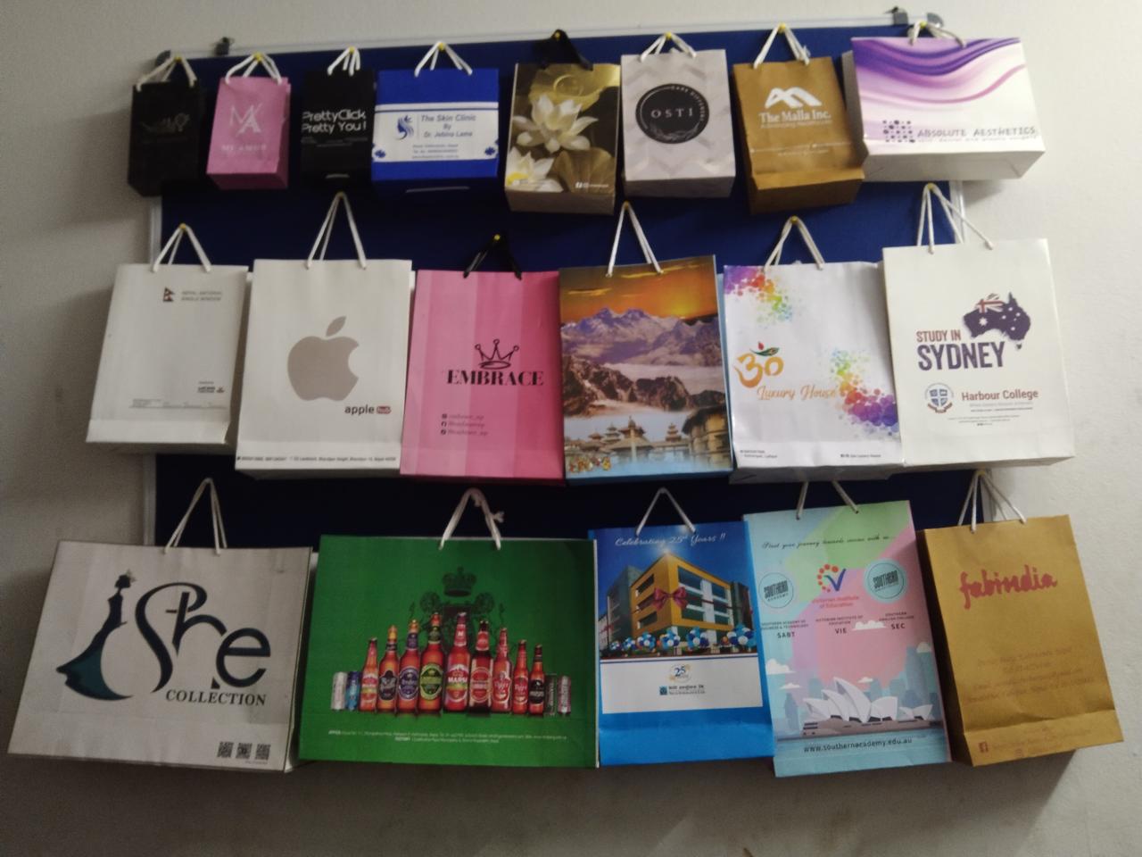 Display wall of printed paper bags produced for clients at International Paper Bag